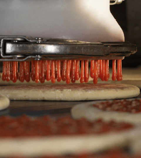 powershot depositing sauce on pizza